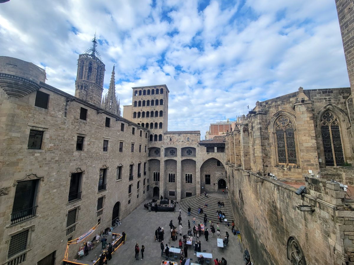 Aerial view of Plaça del Rei courtyard in the Gothic Quarter, with Barcelona Cathedral tower and medieval stone buildings