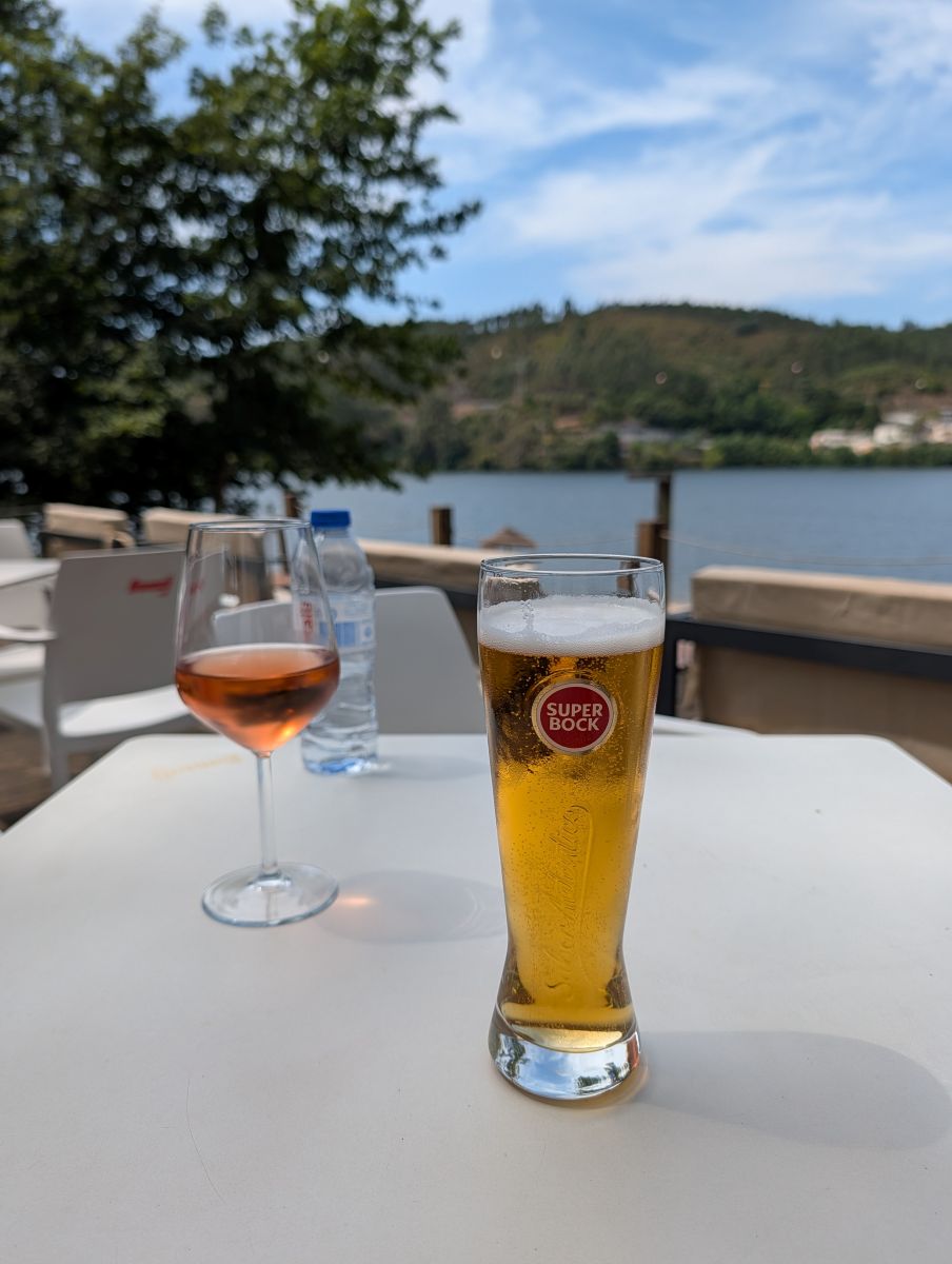 Rosé and Super Bock at a table beside the Douro after the trail