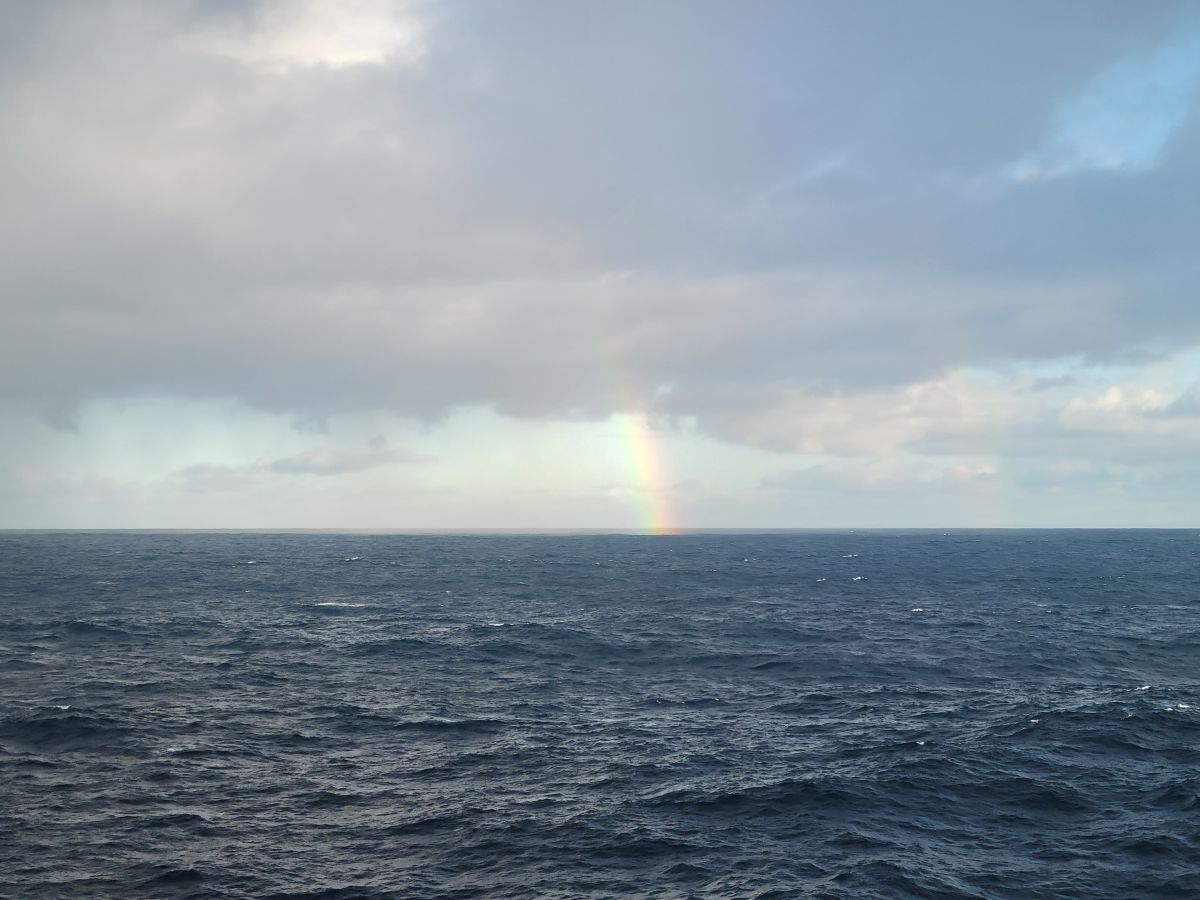 A rainbow arcing over dark choppy seas on a rough day in the Atlantic