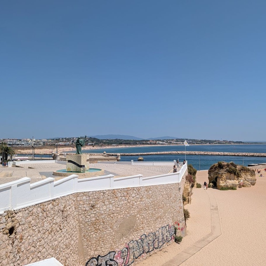 View from the Forte da Ponta da Bandeira over the Lagos harbor entrance, the long beach of Meia Praia stretching into the distance