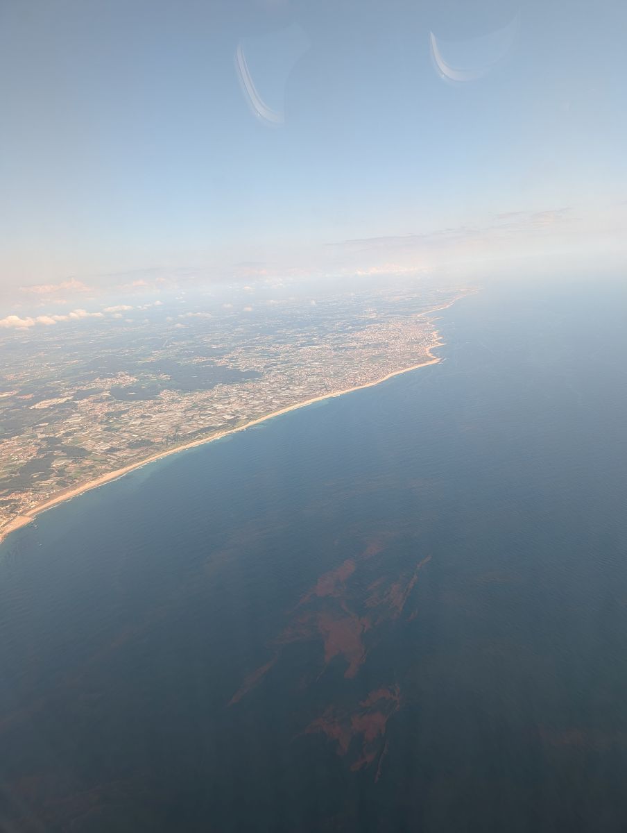 The Portuguese coastline seen from the air — long sandy beaches stretching north toward Porto