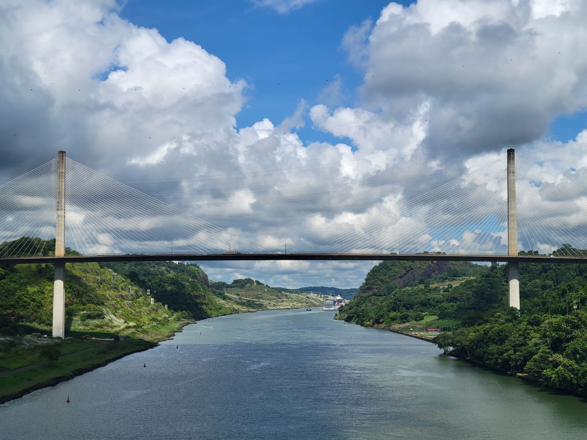 Centennial Bridge perfectly framed with the Panama Canal waterway and a ship passing beneath