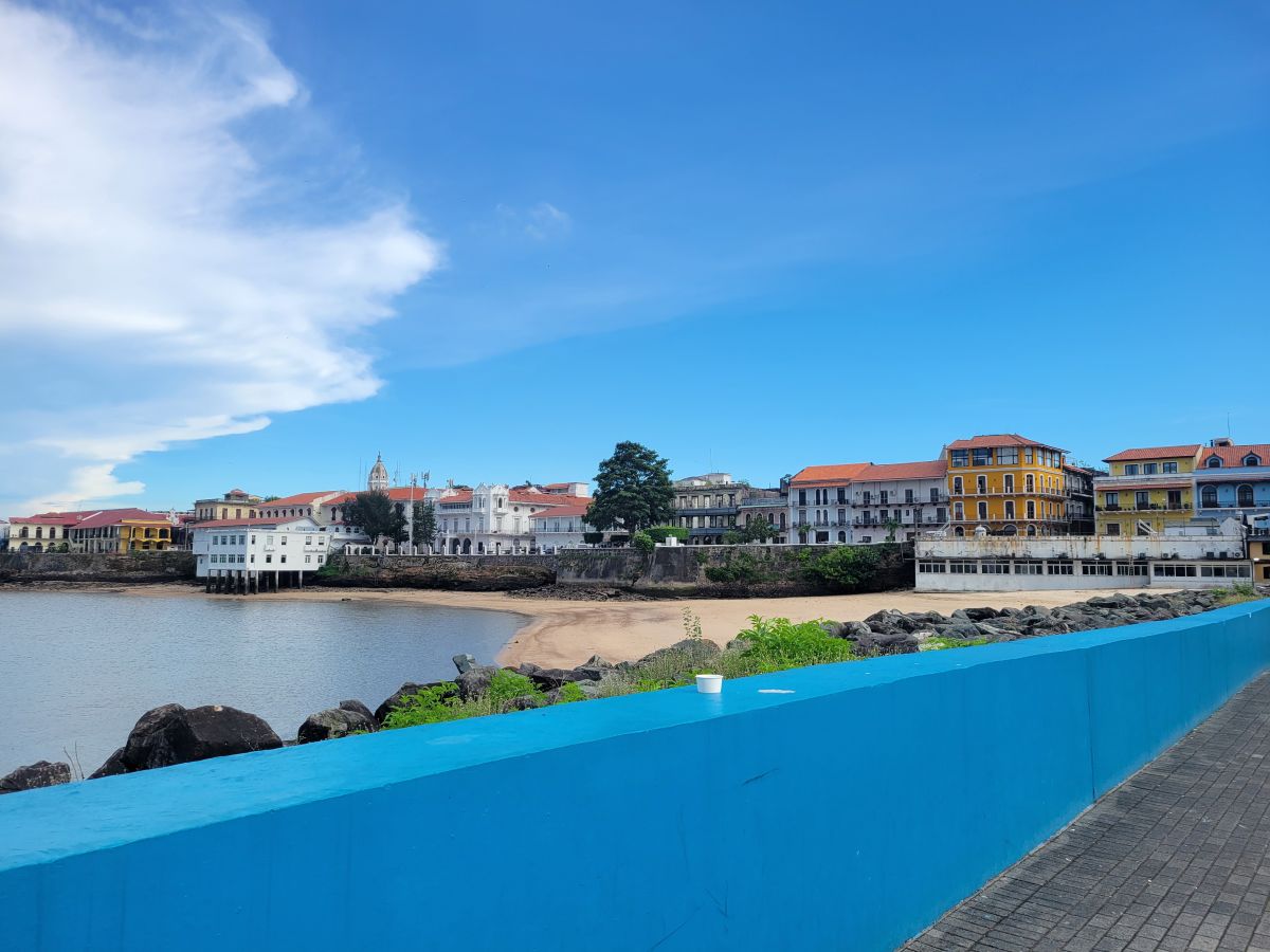 Casco Viejo waterfront with colorful colonial buildings and a sandy cove, Panama City