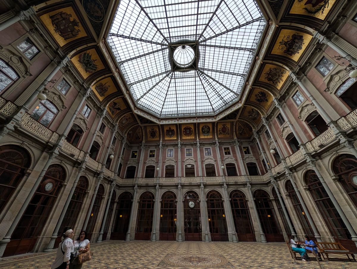 The grand interior atrium of the Palácio da Bolsa with its ornate glass dome