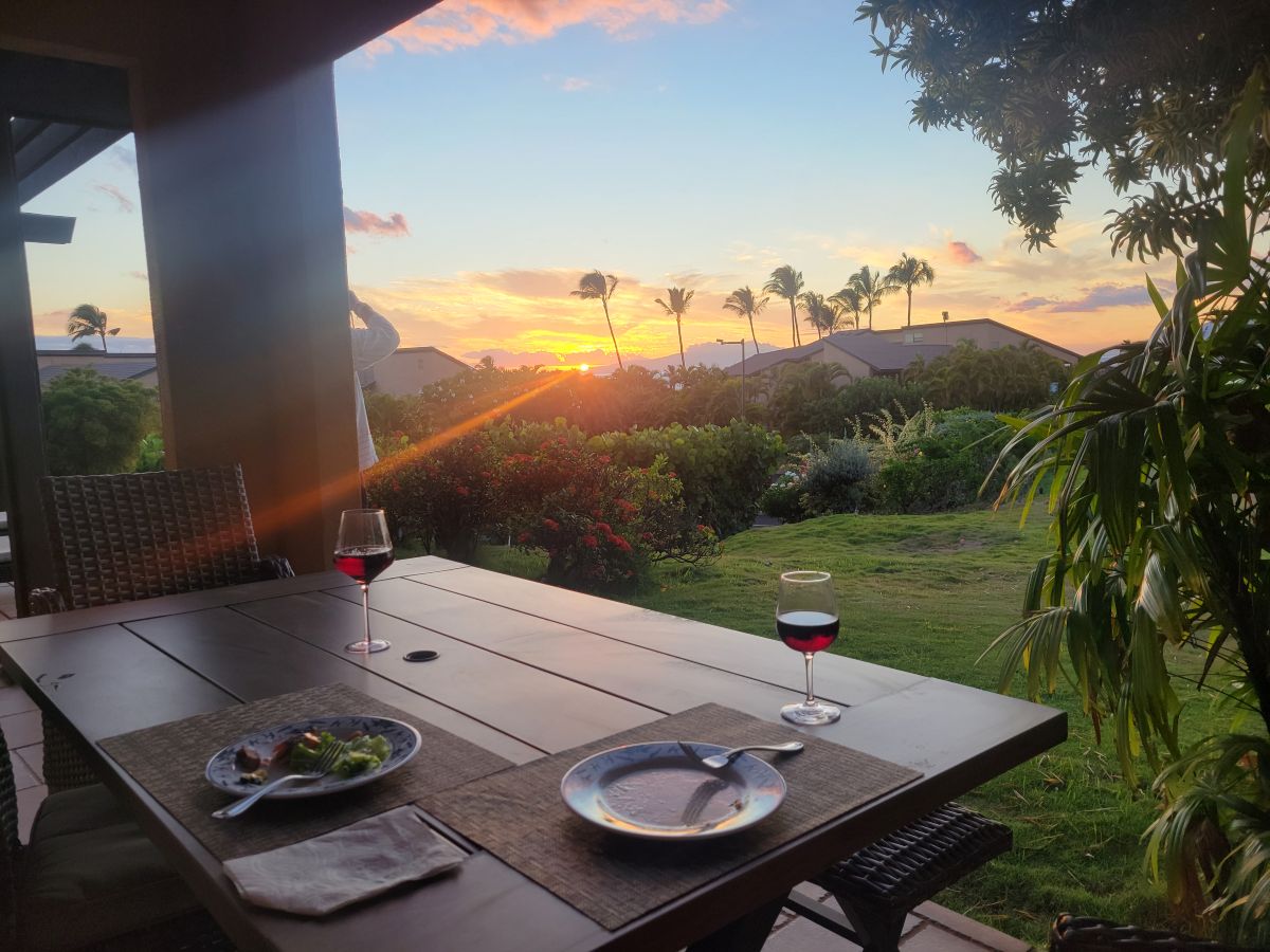 Two glasses of red wine on the patio table at sunset, Wailea Ekahi Village
